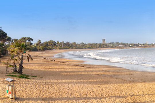Beautiful empty sandy Nagaon beach with it's blue water in the distance at Diu, Gujarat, India. The brown muddy water and with a sandy beach. view of Arabian. The Indian ocean and iconic font of diu