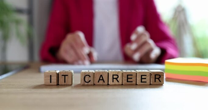 Words IT career in cubes and woman looking for IT specialist