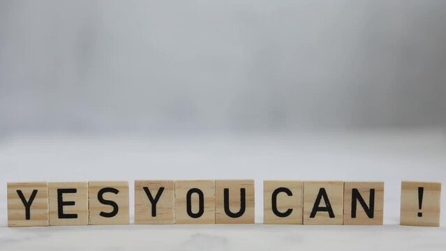 YES you can word concept written on wooden cubes, hand holding exclamation mark, self belief,positive,motivation concept movie