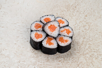 Traditional Japanese cuisine set of sushi rolls with salmon, rice and nori.