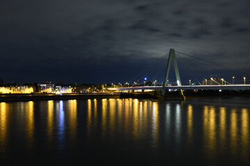 Fototapeta na wymiar Severinsbrucke and the Rhine at night in Cologne, Germany