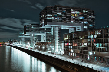 Aerial view of illuminated crane houses by the canal at the Zollhafen in Cologne, Germany at night