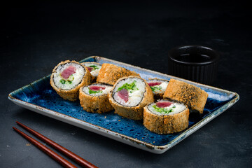 Set of tempura sushi rolls with tuna, cream cheese, cucumber and lettuce.