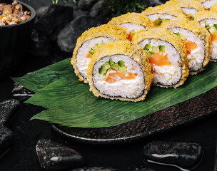 Sushi rolls tempura with salmon on plate. Japanese food style.