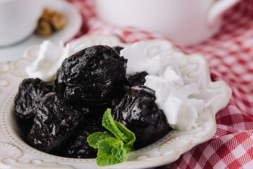 Cup of tea with prunes close up