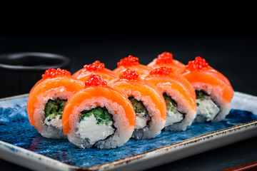 Set of sushi rolls Philadelphia with salmon, cream cheese, cucumber, rice, nori and red flying fish caviar.