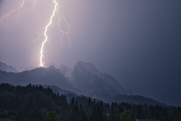 Dramatic lightning strike during a thunderstorm in the Steinberg in Leogang, Salzburg, Austria - obrazy, fototapety, plakaty
