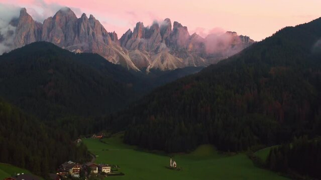 The beautiful massif of the Dolomites of Odle or Geisler group covered with clouds at sunset. 