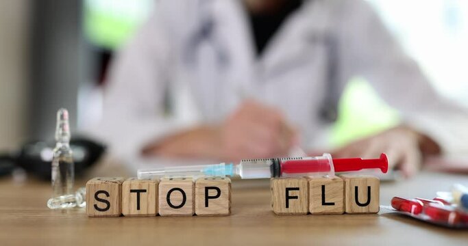 Stop flu word and flu vaccine in syringe