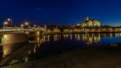 View across the Elbe to the Old Elbe Bridge and the illuminated Albrechtsburg Castle in Meißen Germany