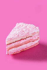 Pink strawberry cake portion on pink background
