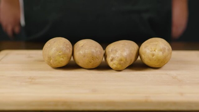Raw potatoes. potato tubers. Cooking at home, food or cook blo. The root of the plant. Hearty food. Starchy and carbohydrate food.