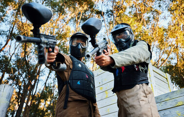 Paintball, sports teamwork and men with gun for game, battle or competition. Collaboration,...