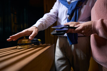 Man in casual clothes calls the hotel staff for registration