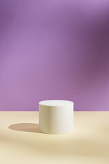 Empty white round podium and soft shadows on light purple and yellow background. Showcase for product presentation. Pedestal for beauty cosmetic advertising. Minimal still life. Front view.