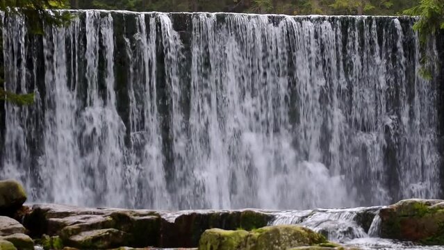 Mountain waterfalls with rocks in the forest, slow motion, zoom in, hd. ProRes 422 HQ.
