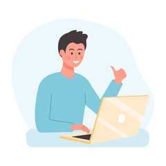 Young man sitting at the desk and using laptop. Office worker showing thumbs up.