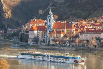 Durnstein village during spring time with tourist ship on Danube river in Wachau (UNESCO), Austria - 579353084
