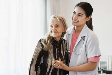 Obraz premium Happy woman caucasian doctor take care caucasian older woman on at home