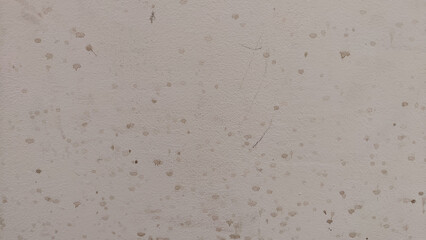 White plaster Texture and background with black dirty spots and drops. Whitewashed Old Wall Surface. Structure and Grungy Shabby Uneven Painted Plaster. White Facade and Abstract Design Element