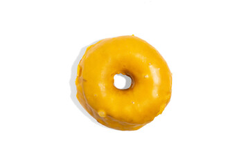 Delicious traditional donut with yellow glaze isolated on blue background. Modern food concept....
