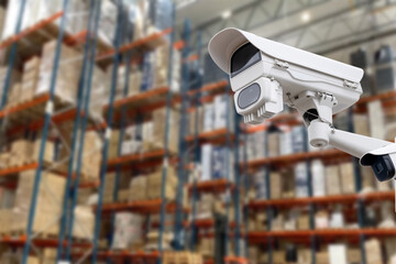 CCTV Camera Operating inside warehouse or factory. Copy space.