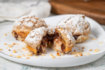 Freshly baked cream puffs. Eclair cake with cream and chocolate filling. Close up