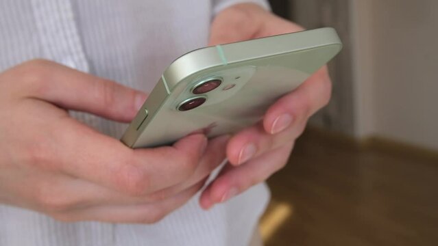Woman using smartphone pressing finger, reading social media internet, typing text or shopping online. Mobile phone at home or work. High quality FullHD footage