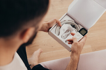 Man unbox a neck device massager