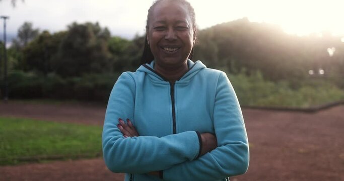 African senior woman looking on camera after sport workout at city park