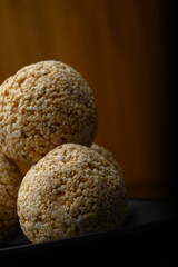 Fototapeta na wymiar Amaranth laddu or Rajgira laddoo made using royal grain also called cholai spherical sweet balls