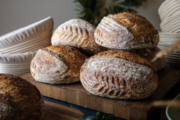 Artisan Batard Sourdough healthy Bread with leaf scoring. Open crumb high hydration Sourdough bread set on white table. - 579360247