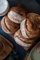 Artisan Batard Sourdough healthy Bread with leaf scoring. Open crumb high hydration Sourdough bread set on white table.