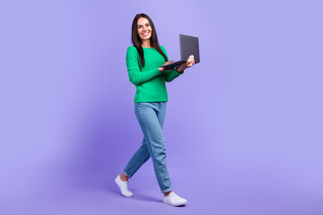 Full size profile photo of model woman walking advertising new netbook laptop limited collection isolated purple color background