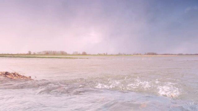 Ijssel river flooding with water running over the floodplains during flooding caused by high water levels after heavy rain in the river in Overijssel The Netherlands