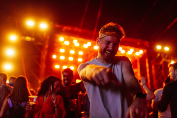 Fototapeta premium Excited young adult dancing at music festival