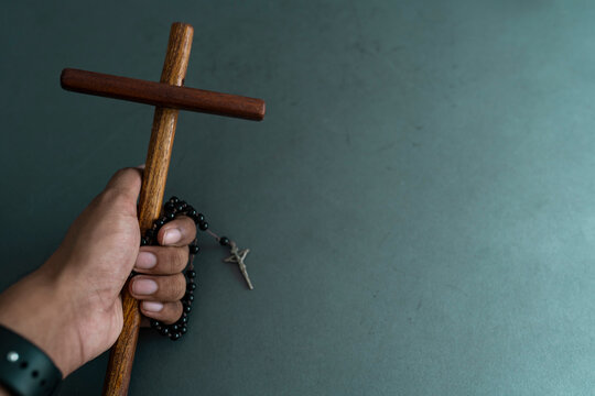 Christianity background wooden cross and prayer beads held, National Christian day Easter Good friday Selective focus