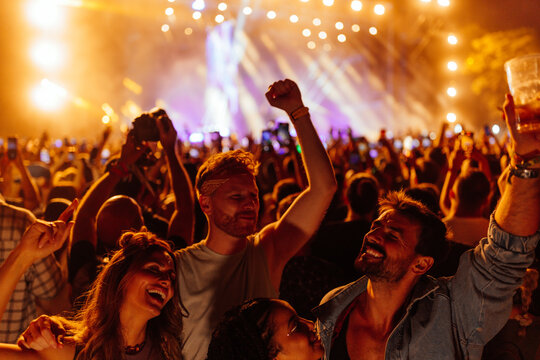 Elated Group Of Young Adults At Concert