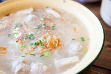 Vietnamese Noodles Including Vietnamese sausage and minced pork topped with spring onions and fried onions in a bowl