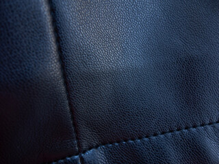 Detail of a black pleated leather garment