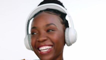 Happy, dancing and black woman with headphones for streaming music, excited and celebration on a studio background. African American female, lady and headset with happiness, audio and girl singing