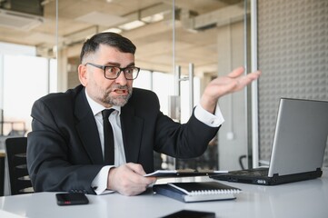 Angry businessman with document shouting at somebody