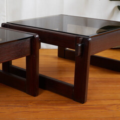 Pair of vintage dark sculpted rosewood side tables. Mid-century modern smoked glass-top side...