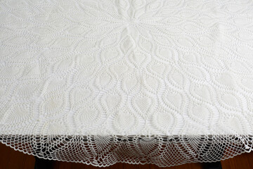Lace tablecloth with repeating circular pattern. Crochet textile design. 