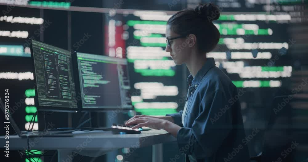 Leinwandbilder Female Developer Thinking and Typing on Computer, Surrounded by Big Screens Showing Coding Language. Professional Programmer Creating Software, Running Coding Tests. Futuristic Concept of Programming