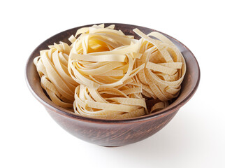 Uncooked tagliatelle pasta in ceramic bowl isolated on white background with clipping path