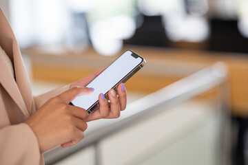 Young businesswoman using smartphone in office