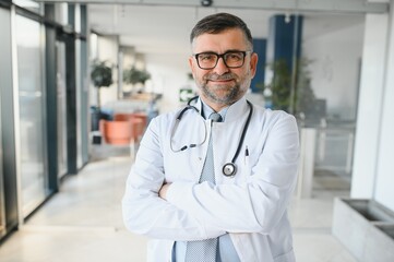 portrait of a senior doctor in his office in a hospital
