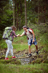 Avanturistic traveler couple hiking together