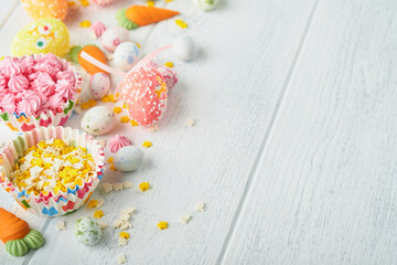 Sweet Easter concept. Sweet Easter kids holiday assortment marshmallows rabbit, chocolates easter eggs, candies, bunny, snacks  on white wooden background. Flat lay Easter decoration idea. Mock up.